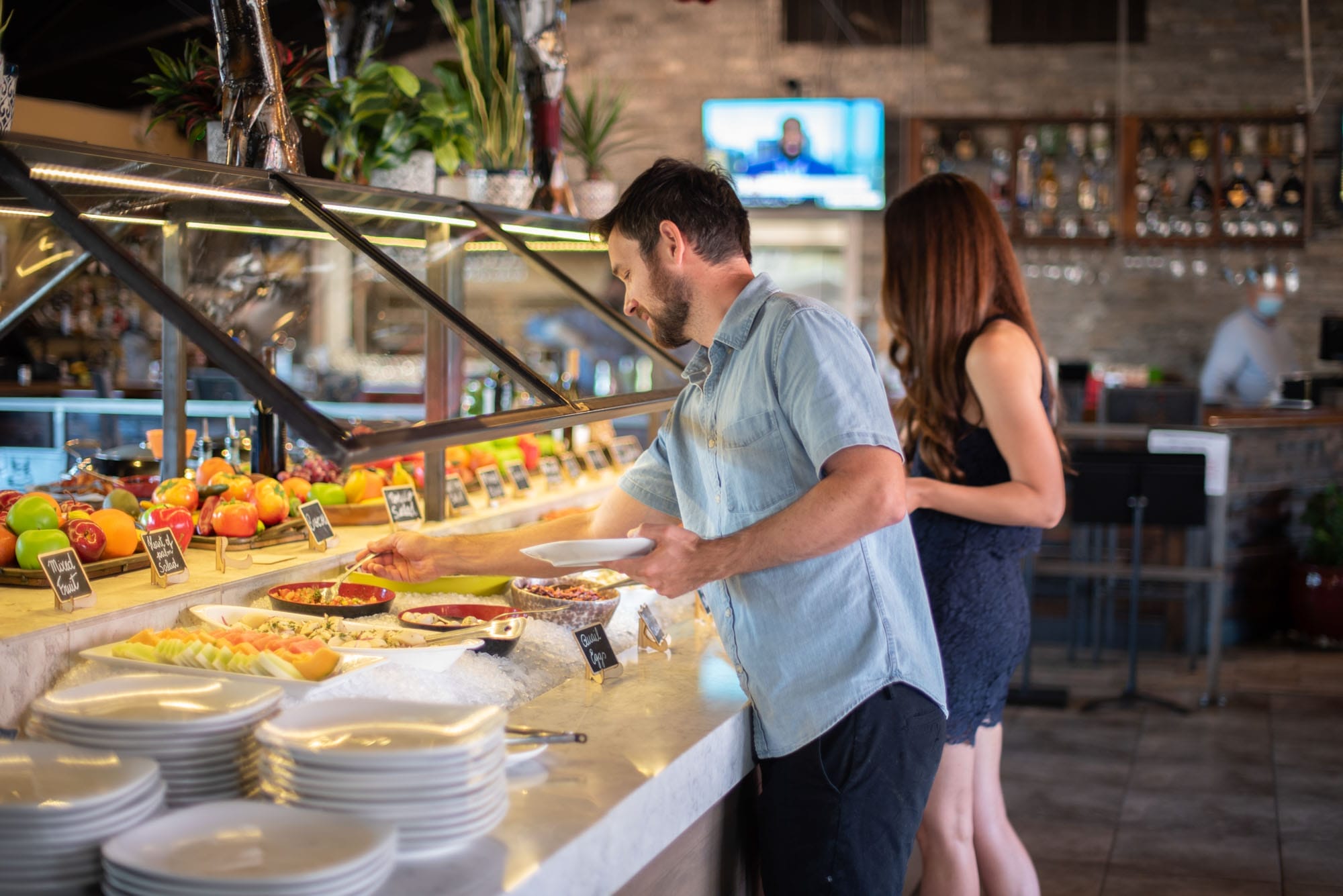 people selecting food from the fresh market table
